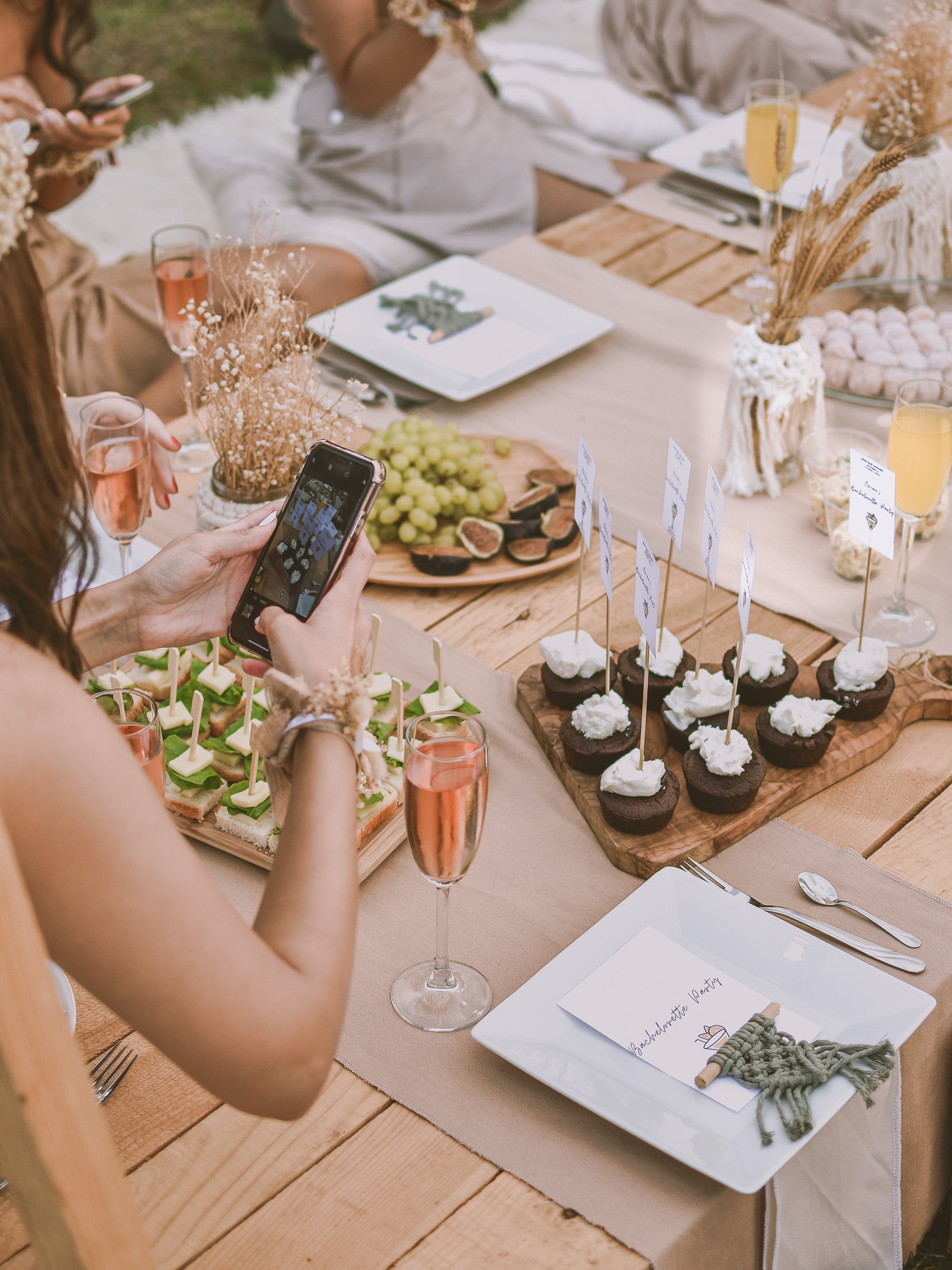 Woman taking photo of dessert table