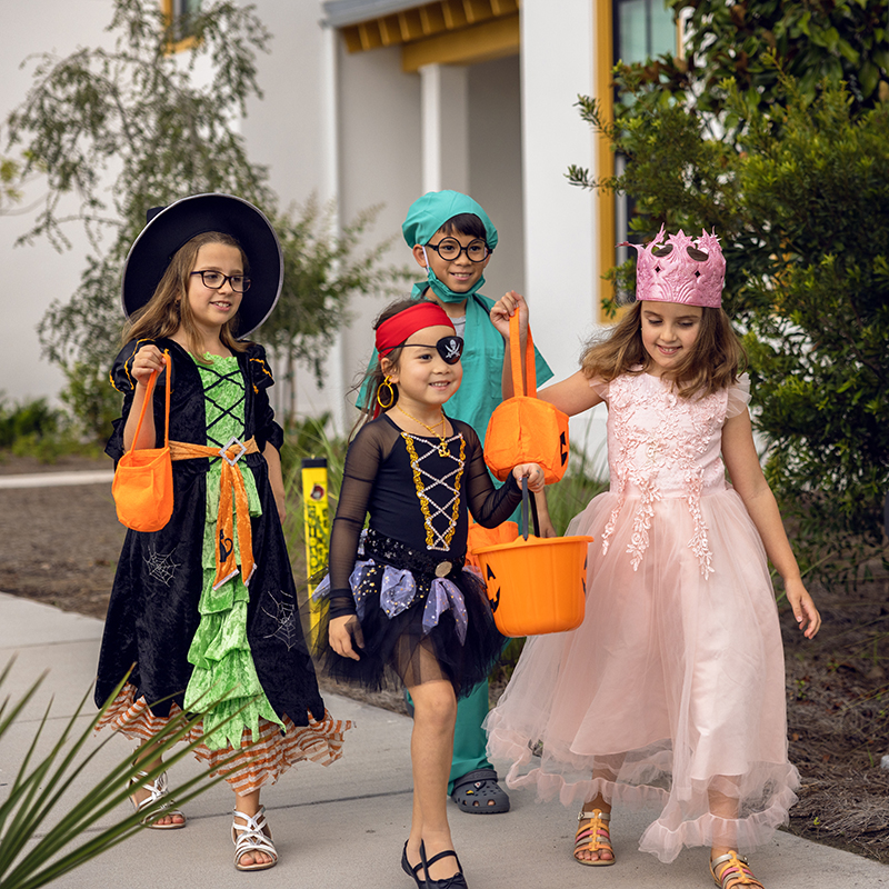 Kids Trick-or-Treating at Evermore Image of children dressed in Halloween costumes while trick-or-treating at Evermore Orlando Resort.