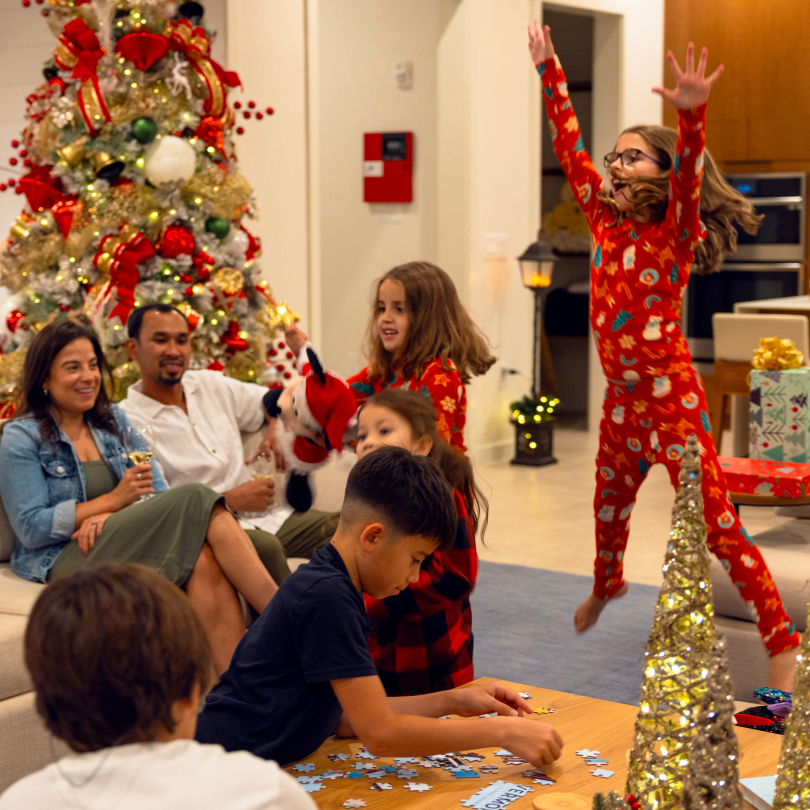 Holidays in an Evermore House Image of a family enjoying quality time together in their vacation home with holiday decorations at Evermore Orlando Resort.